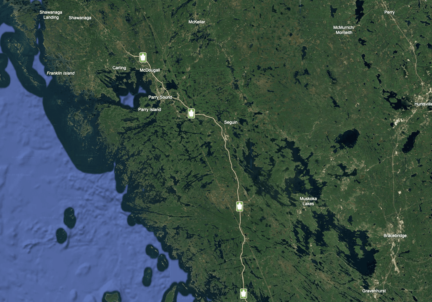 Satellite map of the Parry Sound and Muskoka region, where Georgian Bay meets a dense scattering of lakes across the forested landscape.