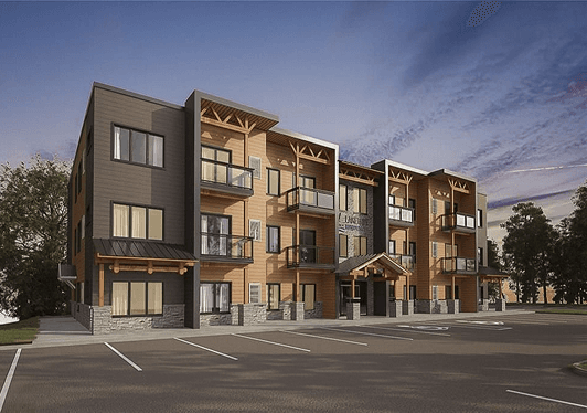 Front exterior at dusk with wooden siding and balconies
